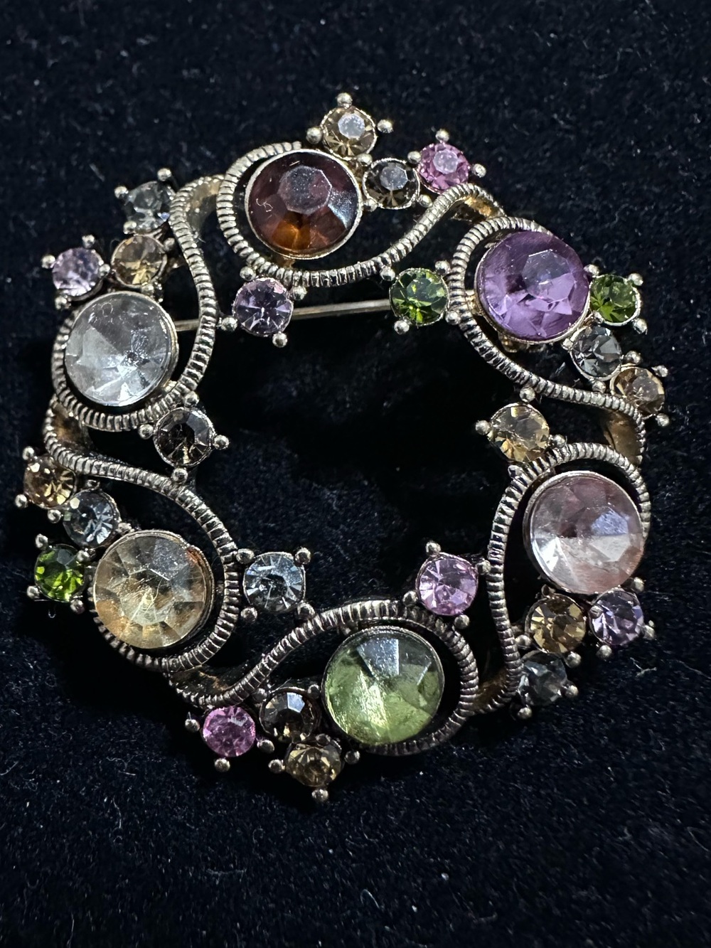 423- Monet wreath brooch features a gold-tone setting